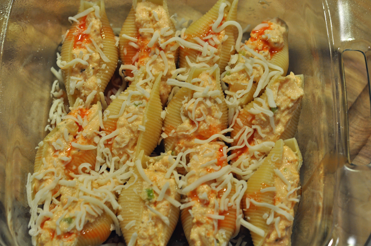 Buffalo Chicken Stuffed Shells topped with cheese