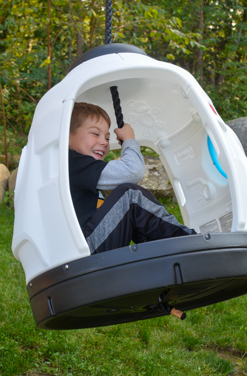 Child swinging with Step2 Space Capsule Swing