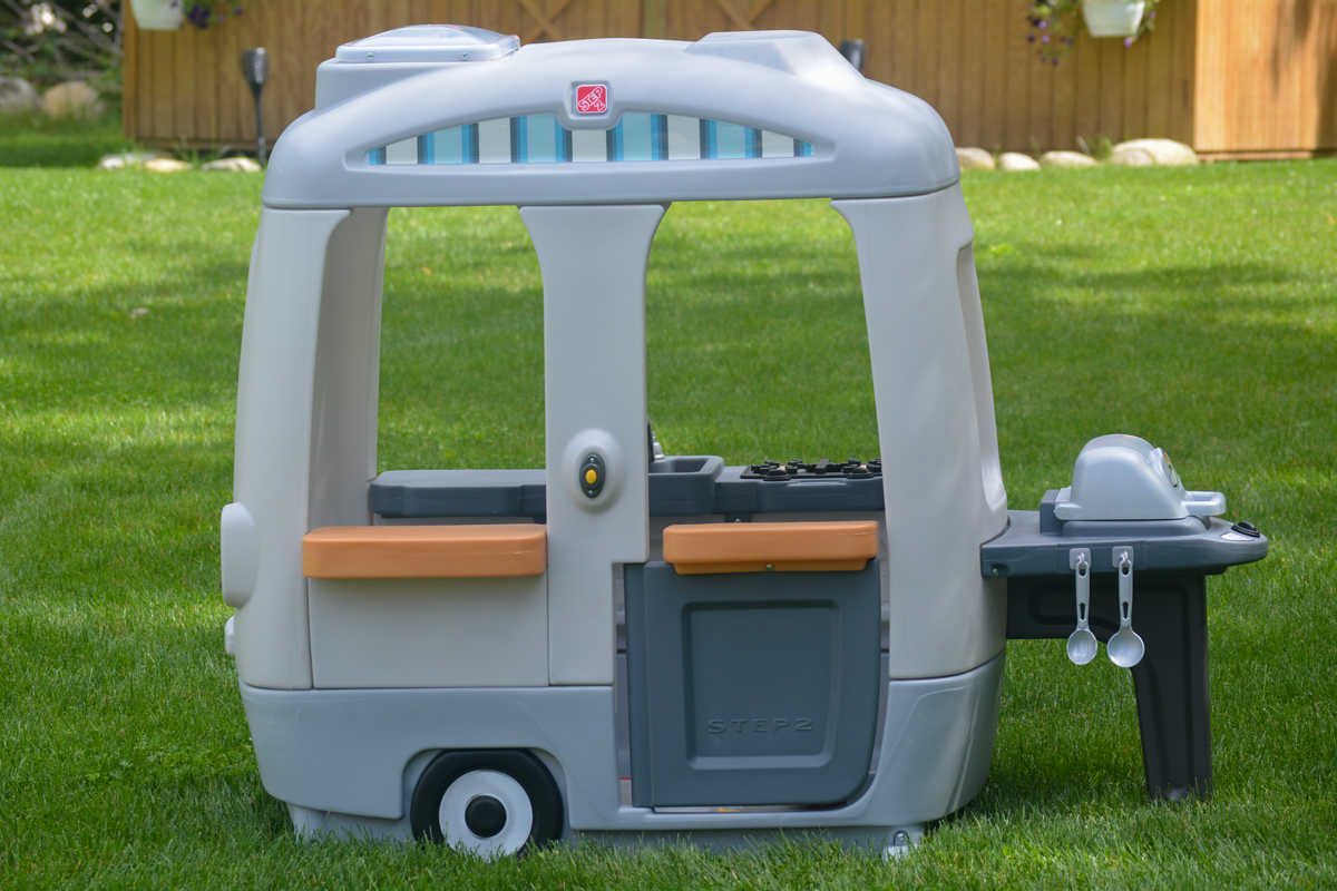 toy camper playhouse in backyard